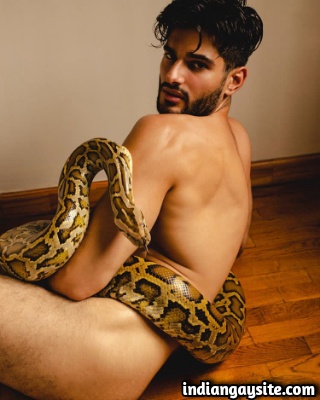 Nude Indian Hunk Posing with a Giant Python