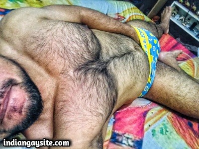 Muscular hairy hunk showing nude body & bulge
