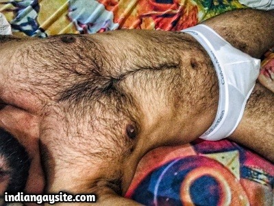 Muscular hairy hunk showing nude body & bulge