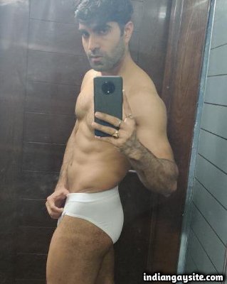 Muscular Indian hunk shows fit body in white briefs