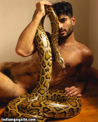 Indian male model posing naked holding a snake