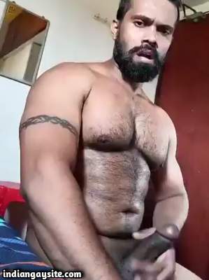 Muscular gay hottie wanking his thick hard cock