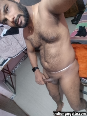 Hairy nude man shows off sexy body and uncut cock