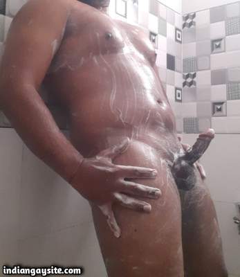 Muscular bathing guy playing with big dick in hot pics